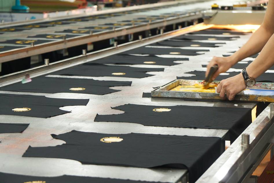 Screen printing t-shirt design with ink and fabric close-up