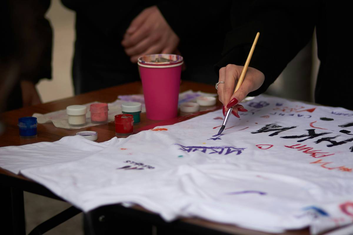diy fashion screen printing shirt technique demonstration showing ink being squeegeed through a screen onto a cotton t-shirt